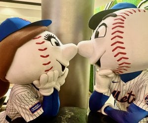 mr and mrs Met mascots looking at each other noses touching